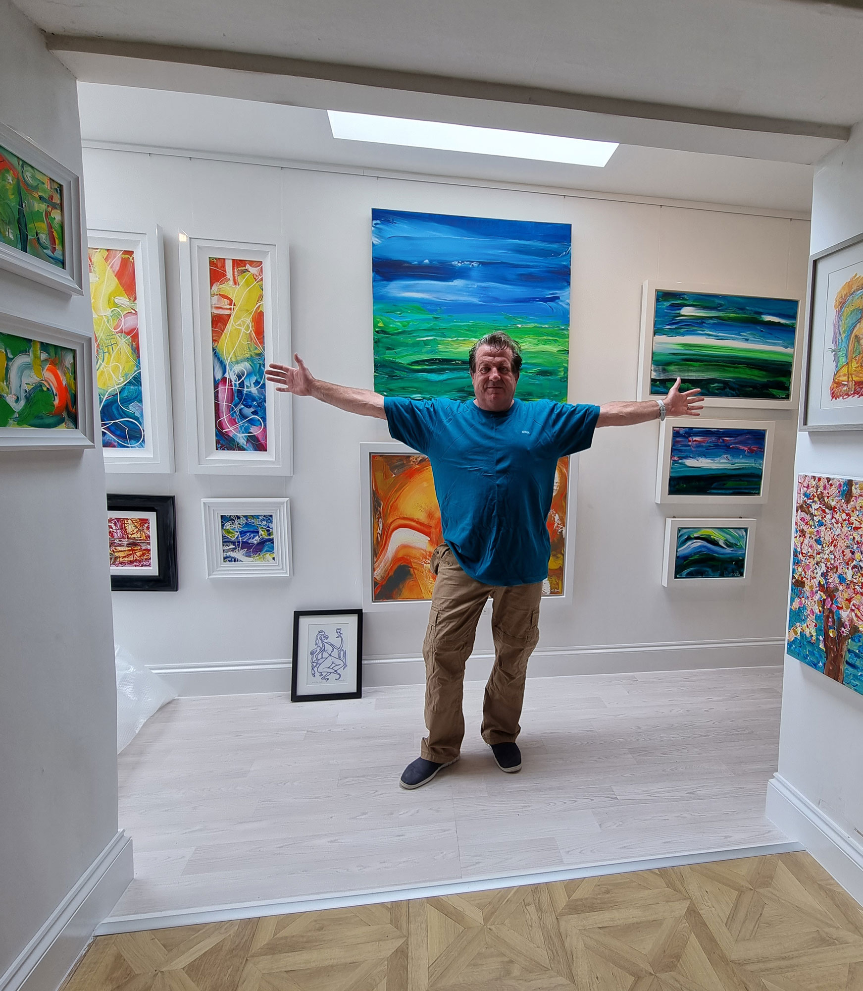 Martin Bush in front of his home gallery wall